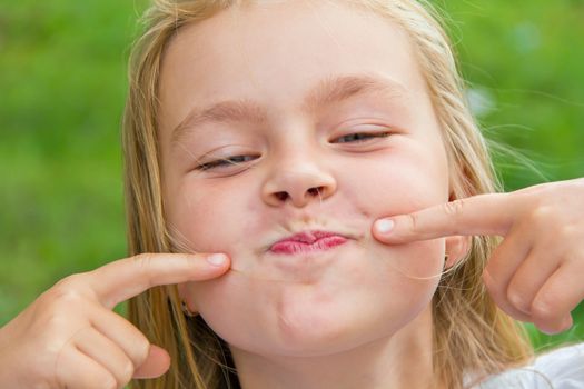 Portrait of cute smiling girl with blond hair