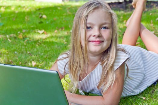 Photo of cute girl with laptop in summer