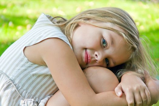 Cute girl with blond long hair and blue eyes