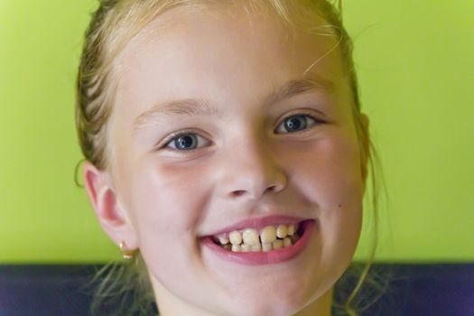 Portrait of cute smiling girl with blond hair
