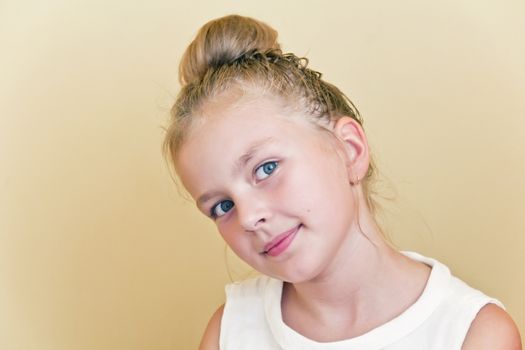 Cute girl with blond long hair and blue eyes