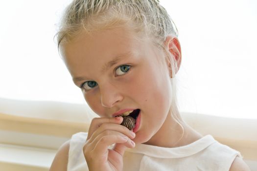 Photo of eating cute girl with blond hair