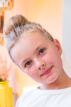 Cute girl with blond long hair and blue eyes