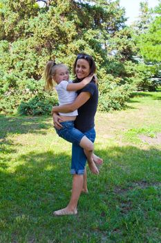 Photo of mother and daughter playing in summer