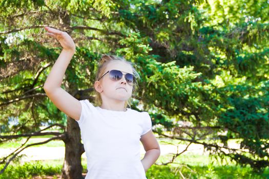 Photo of cute dancing girl with sunglass in summer