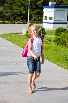 Cute girl go to school with pink knapsack