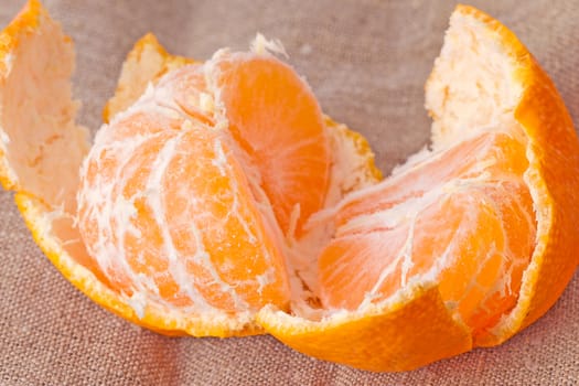 Disassembled tangerine close up on a sacking