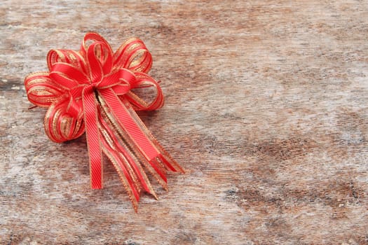 Red Ribbon on Old Wood Background