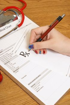 A female practitioner writes a prescription for one of her needing patients.