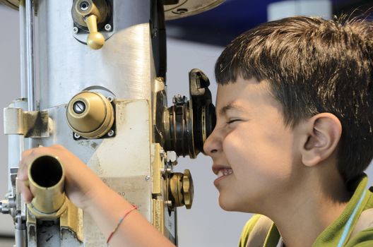 Curious child looking through the periscope the external environment.