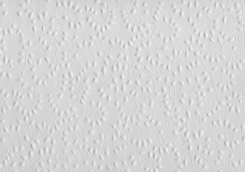 Embossed pattern with floral designs on white paper