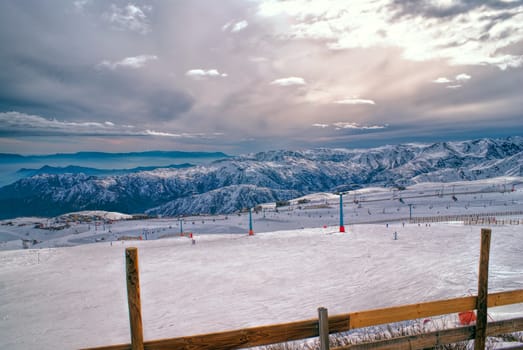 Picturesque view of piste in Valle Nevado under gloomy grey sky