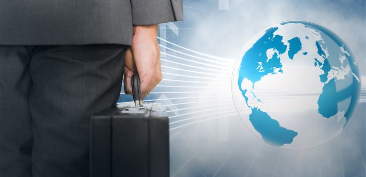 Businessman holding briefcase against global business graphic in blue