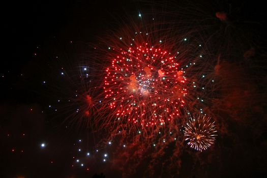 Celebrating firework in the black night sky