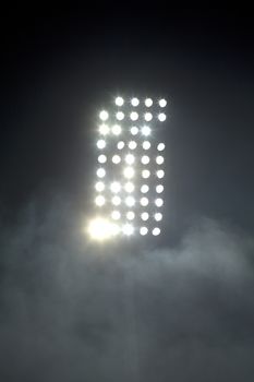 Stadium lights against dark night sky background