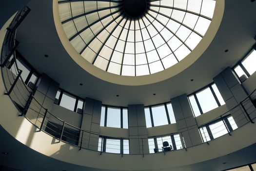 Interior of a circular modern building with glass dome