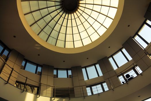 Interior of a circular modern building with glass dome