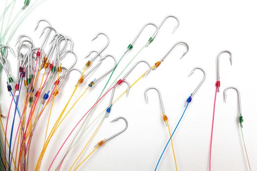 A fishing hooks tied with fishing line, isolated against a white background