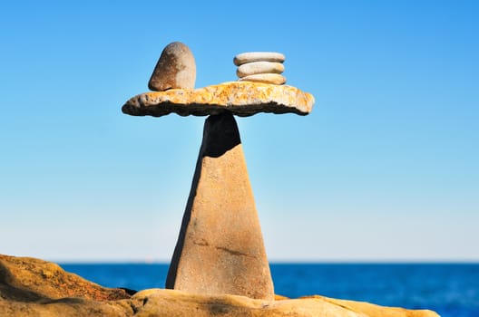 Balancing of pebbles on the top of triangle stone