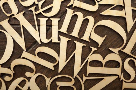 Wooden alphabet letters on old wooden surface