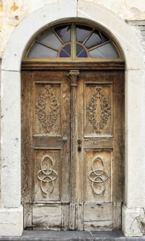 Old wooden door, with many carved details.