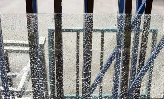Broken safety glass on a metal frame.