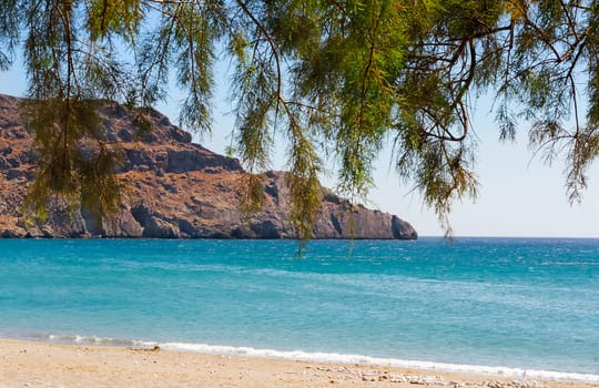 Landscape with sea view, sandy beach, rocky island. The southern coast of Crete, Greece.