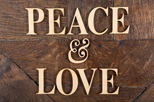 Wooden letters forming words PEACE & LOVE written on old vintage wooden plates