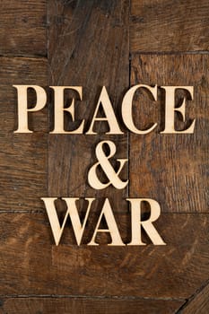 Wooden letters forming words PEACE & WAR written on old vintage wooden plates
