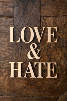 Wooden letters forming words LOVE & HATE written on old vintage wooden plates