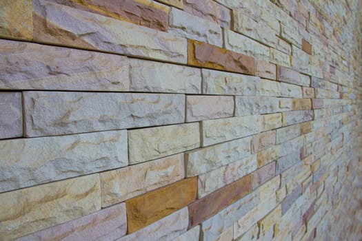 Close up of modern style design decorative uneven cracked real stone wall surface with cement