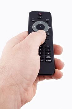 Hand holding TV remote control on white background