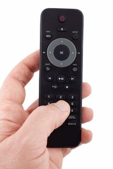 Hand holding TV remote control on white background