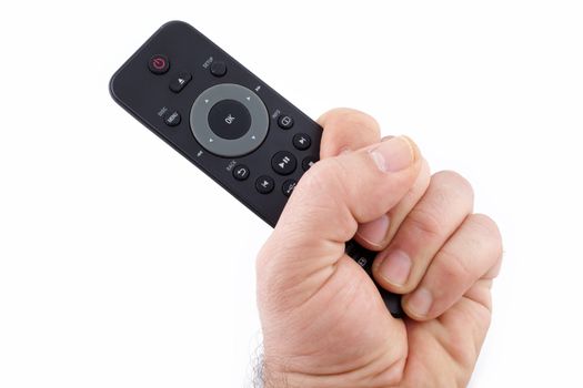 Hand holding TV remote control on white background