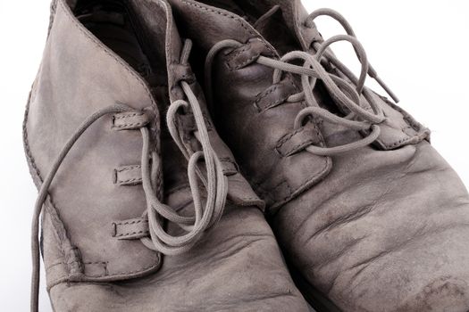 Pair of old leather boots isolated on the white background
