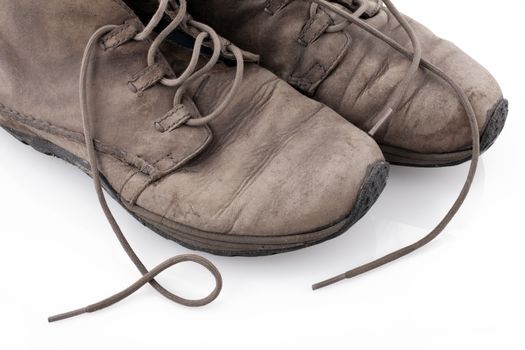 Pair of old leather boots isolated on the white background