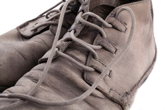 Pair of old leather boots isolated on the white background