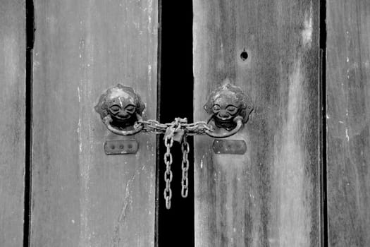 Closeup of an old keyhole with key on a wooden antique door