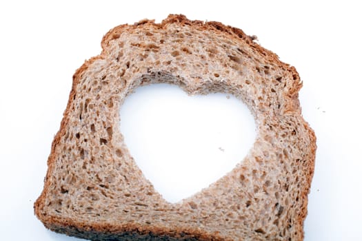 Piece of bread toast cut hole in shape of heart Isolated on white background