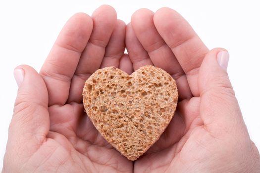 Food with love - helping the poor concept. ��ands holding a heart of bread