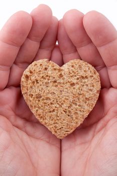 Food with love - helping the poor concept. Ηands holding a heart of bread