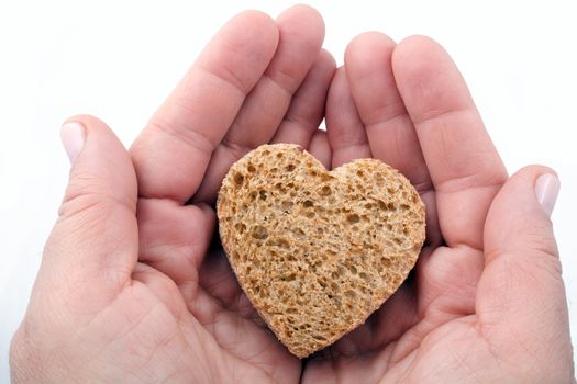 Food with love - helping the poor concept. Ηands holding a heart of bread