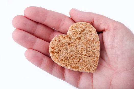 Food with love - helping the poor concept. Ηand holding a heart of bread