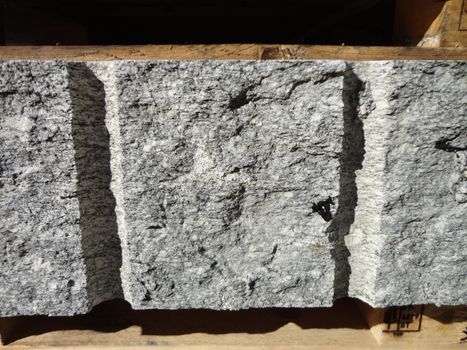 A manufactured industrial cutting of granite rock. Section View.