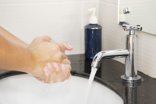 washing hand in a sink 