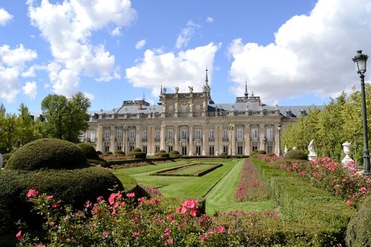 Palace, garden and flowers in foreground. La Granja de San Ildefonso, Segovia, Spain