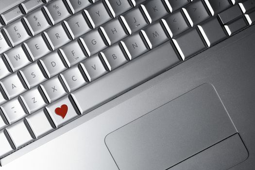 Keyboard of a notebook computer with a red heart