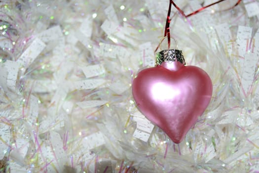 pink heart and white garland. Christmas balls with the shape of a heart