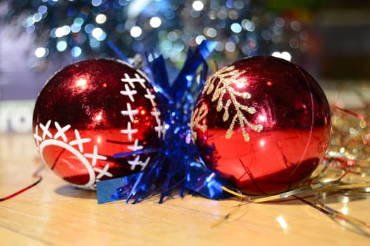 red christmas balls, blue garland, on a wooden floor