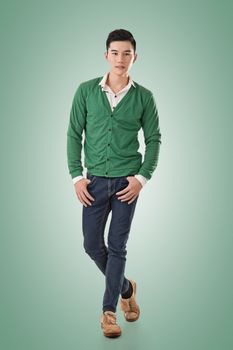 Handsome young Asian man with sweater, full length portrait isolated.